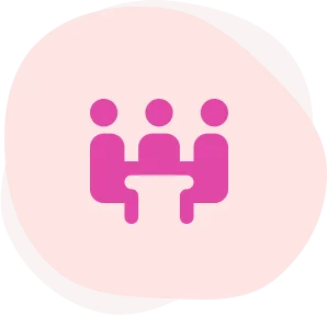 A pink icon of three people sitting at a table.