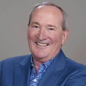 Smiling man in blue suit jacket.